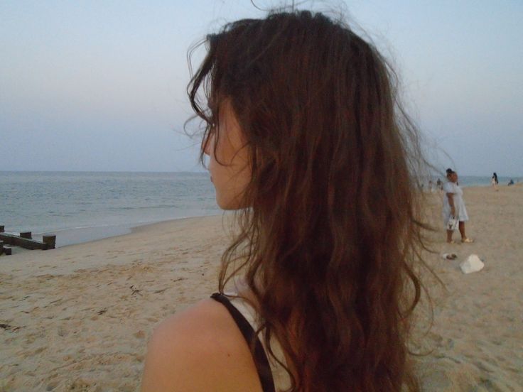 Girl with wavy hair at the beach