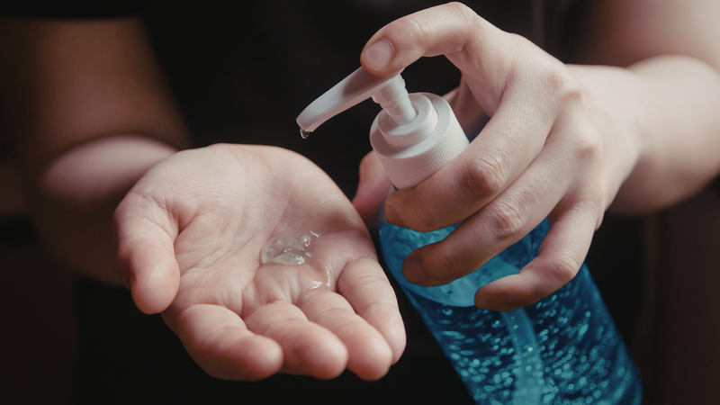 Person pumping hand sanitizer on their hands