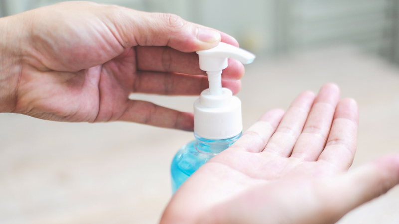 Person using hand sanitizer on their hand